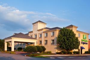 a hotel building with a clock on top of it at Baymont by Wyndham Merrillville in Merrillville