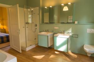 a bathroom with two sinks and a shower and a toilet at Forsthaus Edelburg Ferienhaus in Hemer +50 photos