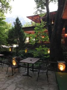 a patio with a table and chairs and a building at Margaret's Island Hotel in Naousa