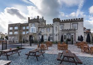 a building with tables and chairs in front of it at Ryde Castle by Greene King Inns in Ryde
