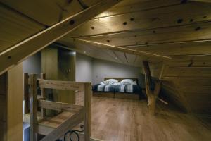 a bedroom with a bed in a room with wooden ceilings at Apartament An-Mi in Zakopane