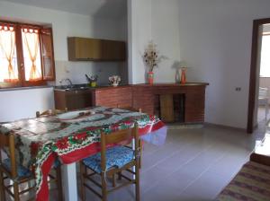 a kitchen with a table and some chairs and a table sidx sidx sidx at Agriturismo Collevento in Trecchina