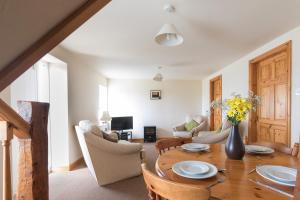 a living room with a wooden table and chairs at Milton Cottage in Whitby