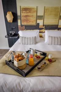 a tray of food on top of a bed at Thalazur Arcachon in Arcachon