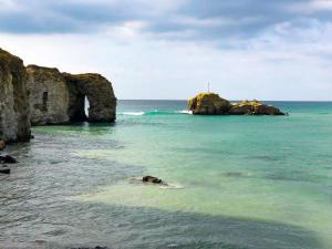 a view of the ocean with rocks in the water at Chapel Rock View, The Dunes in Perranporth