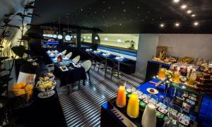 - un restaurant avec des tables et des chaises dans une salle dans l'établissement Hotel Splendor Elysées, à Paris