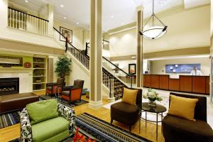 a living room with a fireplace and a tv at Country Inn & Suites by Radisson, Evansville, IN in Evansville