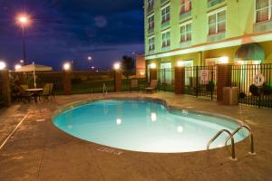 - une piscine en face d'un bâtiment la nuit dans l'établissement Country Inn & Suites by Radisson, Evansville, IN, à Evansville