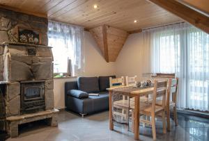 a living room with a table and a fireplace at Apartament An-Mi in Zakopane