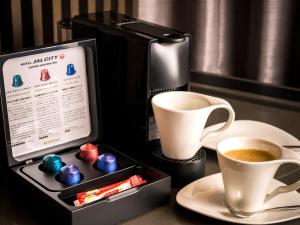 a box of chocolates next to a cup of coffee at Hotel JAL City Sapporo Nakajima Park in Sapporo