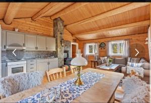 a kitchen and living room with a wooden ceiling at Trollhaugen in Snillfjord