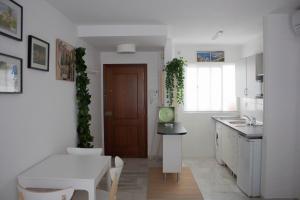 eine Küche mit einem Tisch und einer weißen Arbeitsplatte in der Unterkunft centrico apartamento nuevo, zona corte ingles in Málaga