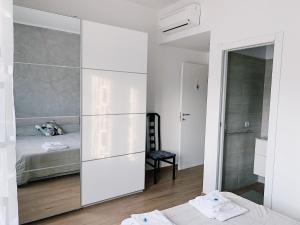 a bedroom with a large white closet and a bed at RomAmourHouse in Rome