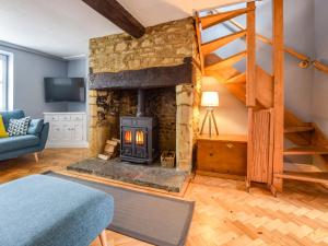 a living room with a fireplace and a staircase at 27 Horsefair in Malmesbury