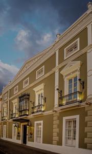 a large building with balconies on a street at Hotel Boutique Casa Conde in Zafra