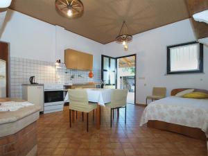 a kitchen and a bedroom with a bed and a table at Apartments Boris 1965 in Pula