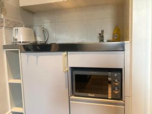 a kitchen with a counter with a microwave at Stylish Studio Room in Brixton - E in London