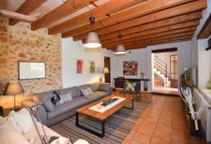 a living room with a couch and a table at Finca Siscelis 063 by Mallorca Charme in Santa Maria del Camí