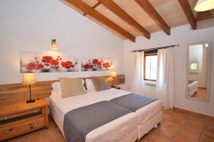 a bedroom with a large bed and a window at Finca Siscelis 063 by Mallorca Charme in Santa Maria del Camí +30 photos