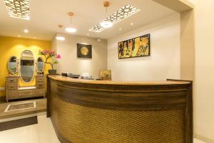 a salon with a wooden bar in a room at Hotel Ameya in Mumbai