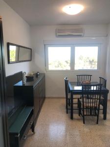 a dining room with a table and a table and chairs at El Balcón de Sevilla in Seville