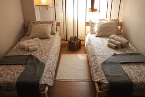 two beds in a small room with two pillows at Sweet Home Milano B&B in San Donato Milanese