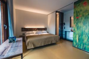 1 dormitorio con 1 cama y 1 mesa en Hotel y Estudios DCeres Estancias, en Santa María de Mave