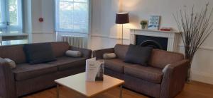 a living room with a couch and a coffee table at Acorn - Bedford Place Apartments in London