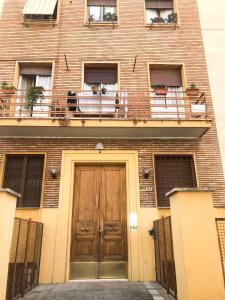 a brick building with a wooden door and windows at Delizioso Appartamento in Via di Monte Verde in Rome