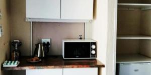 a microwave sitting on a counter in a kitchen at The Owl's Nest Guesthouse in Tom Burke
