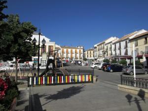a playground in the middle of a street with buildings at Apartamento Terranova La Placeta in Alhama de Granada
