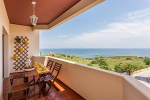 d'un balcon avec une table et des chaises donnant sur l'océan. dans l'établissement WOW View, 5m to Beach,10min City, à Lagos