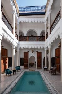 an indoor swimming pool in a large room with a building at Riad Spice by Marrakech Riad in Marrakesh