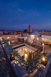 a building with a swimming pool at night at Riad Spice by Marrakech Riad in Marrakesh
