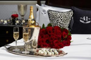 a tray with a bottle of champagne and a bouquet of red roses at 41 in London