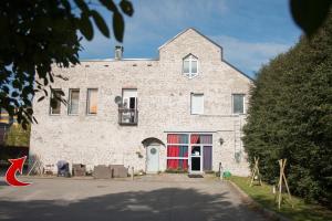 a large brick building with a red door at Studio Apartment Lahti in Lahti