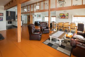 a living room with leather furniture and a table at Lofoten Seaview Villa in Leknes
