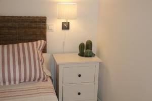 a bedroom with a bed and a night stand with a cactus at Apartamento Homelife Sacramento in Toledo