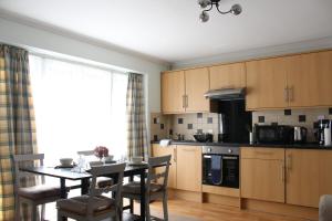 a kitchen with a table and a dining room at Comfortable and spacious apartment with parking in Canterbury
