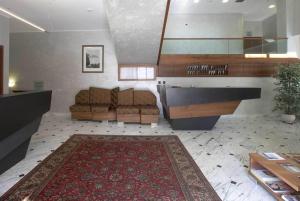 a living room with a couch and a rug at Hotel Iris in Genoa