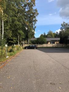 a black car parked in the driveway of a house at Spot Apartments Rajakylä in Vantaa