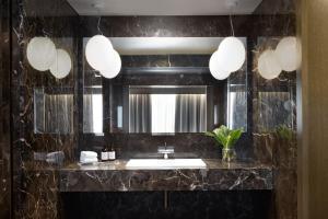 La salle de bains est pourvue d'un lavabo et d'un miroir. dans l'établissement Kimpton - Blythswood Square Hotel, an IHG Hotel, à Glasgow