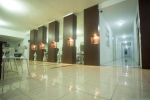a hallway of a building with lights on the walls at SUPER OYO 850 Lapan Lapan in Banjarmasin