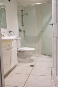 a bathroom with a shower and a toilet and a sink at Focus OCEAN VIEW in Gold Coast