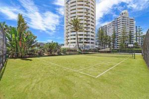 a tennis court in front of some tall buildings at Focus OCEAN VIEW in Gold Coast
