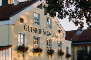 a building with a sign on the side of it at Gutshof Sagmühle in Bad Griesbach