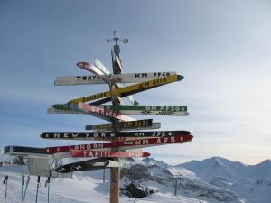 a directional sign on top of a snow covered mountain at Chasa Monthani in Ischgl