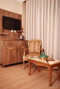 a living room with a chair and a table at Hasekisultan Suite House in Istanbul