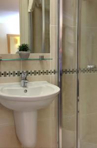a bathroom with a sink and a shower at Best Western London Highbury in London