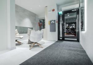 a lobby with a white chair and a window at HAAWE Boutique Apart Hotel in Rovaniemi